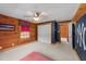 Spacious bedroom with natural wood walls, unique accent walls, and natural light at 407 Howard Tant Rd, Zebulon, NC 27597