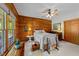 Bedroom with wood-paneled accent wall, white floors, and bright natural light from the windows at 407 Howard Tant Rd, Zebulon, NC 27597