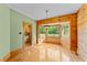 Bright dining room with wood paneling, hardwood floors, and large bay windows at 407 Howard Tant Rd, Zebulon, NC 27597