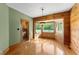 Bright dining area with wood paneled walls and bay window offering natural light and views at 407 Howard Tant Rd, Zebulon, NC 27597