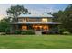 Log cabin with a cozy covered porch and lush front lawn at 407 Howard Tant Rd, Zebulon, NC 27597