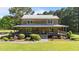 Log cabin featuring a covered porch, stone walkway and manicured landscaping at 407 Howard Tant Rd, Zebulon, NC 27597