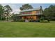 Charming log cabin with inviting front porch and meticulously landscaped front yard at 407 Howard Tant Rd, Zebulon, NC 27597