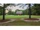 View of front exterior featuring a sprawling green lawn and covered porch at 407 Howard Tant Rd, Zebulon, NC 27597