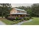 Charming log cabin with inviting front porch and meticulously landscaped front yard at 407 Howard Tant Rd, Zebulon, NC 27597