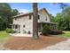 Rustic log home showcasing its natural wood exterior and outdoor patio space at 407 Howard Tant Rd, Zebulon, NC 27597