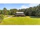 Beautiful front yard with sprawling lawn, mature trees, and a charming two-story home at 407 Howard Tant Rd, Zebulon, NC 27597