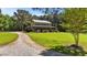 View of the charming two-story home with a long driveway and expansive front lawn at 407 Howard Tant Rd, Zebulon, NC 27597