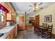 Cozy kitchen with wood cabinets, tile flooring, dining area, and open layout to living spaces at 407 Howard Tant Rd, Zebulon, NC 27597