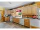 Functional kitchen featuring ample cabinets, laminate countertops, and white appliances at 407 Howard Tant Rd, Zebulon, NC 27597