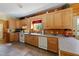 Functional kitchen featuring wood cabinets, modern appliances, and ample counter space at 407 Howard Tant Rd, Zebulon, NC 27597
