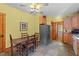 Cozy kitchen with stainless steel refrigerator and access to the backyard at 407 Howard Tant Rd, Zebulon, NC 27597