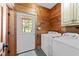 Spacious laundry room features a full-size washer and dryer and wood paneling at 407 Howard Tant Rd, Zebulon, NC 27597