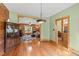 Open-concept living space featuring hardwood floors and seamlessly flowing from dining to seating area at 407 Howard Tant Rd, Zebulon, NC 27597