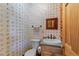 This half-bath boasts unique wallpaper, a stylish vanity, and a charming mirror at 407 Howard Tant Rd, Zebulon, NC 27597