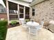 Charming back patio with white metal table and chairs, perfect for outdoor dining and relaxation at 409 Eagle Ct, Henderson, NC 27536