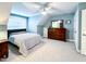 Spacious bedroom with large windows, a ceiling fan, and neutral carpet and paint at 409 Eagle Ct, Henderson, NC 27536