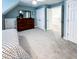 This neutral-toned bedroom features a sloped ceiling, carpet and closet at 409 Eagle Ct, Henderson, NC 27536