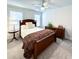 Bedroom with a ceiling fan, dark wood furniture, and neutral carpet and paint at 409 Eagle Ct, Henderson, NC 27536