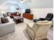 Relaxing bonus room with plush sofas, wooden coffee table, and a mounted television for leisure at 409 Eagle Ct, Henderson, NC 27536