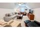 Cozy bonus room featuring comfortable seating, a ceiling fan, and a large TV for relaxation and entertainment at 409 Eagle Ct, Henderson, NC 27536