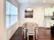 Cozy dining area features a wooden table with seating near bright windows at 409 Eagle Ct, Henderson, NC 27536