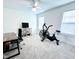 Large room with a ceiling fan and a variety of exercise equipment at 409 Eagle Ct, Henderson, NC 27536