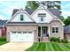 Charming brick home with manicured lawn, two-car garage, and inviting front entrance at 409 Eagle Ct, Henderson, NC 27536
