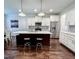 Modern kitchen boasts stainless appliances, an island with bar stools, and ample cabinet space at 409 Eagle Ct, Henderson, NC 27536