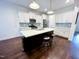 Contemporary kitchen featuring a center island, white cabinetry, and stainless steel appliances at 409 Eagle Ct, Henderson, NC 27536