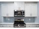 Kitchen featuring stainless steel microwave and gas range at 409 Eagle Ct, Henderson, NC 27536
