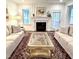 Comfortable living room with a fireplace, stylish decor, area rug, and a calming neutral color palette at 409 Eagle Ct, Henderson, NC 27536