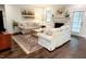 Spacious living room with a fireplace, hardwood floors, a patterned rug, and comfortable seating at 409 Eagle Ct, Henderson, NC 27536