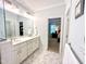 Bright bathroom featuring double sinks, white cabinets, and tile flooring at 409 Eagle Ct, Henderson, NC 27536