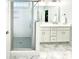 The bathroom offers double sinks, a glass door shower and lovely tile work at 409 Eagle Ct, Henderson, NC 27536