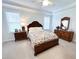 Bright main bedroom with neutral carpet, and an elegant wood dresser at 409 Eagle Ct, Henderson, NC 27536