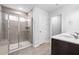 Modern bathroom featuring a glass-enclosed shower and a double vanity with white countertops at 413 Providence Springs Ln, Fuquay Varina, NC 27526