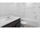 Bright bathroom featuring a vanity with solid surface top and tub shower combo at 413 Providence Springs Ln, Fuquay Varina, NC 27526