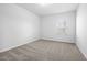 Empty bedroom featuring carpeted floors, a window, and neutral walls at 413 Providence Springs Ln, Fuquay Varina, NC 27526