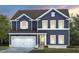 Charming two-story home with blue siding, white trim, and a well-manicured lawn at 413 Providence Springs Ln, Fuquay Varina, NC 27526