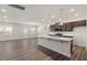 Bright, open kitchen with dark cabinets, granite countertops, and stainless steel appliances at 413 Providence Springs Ln, Fuquay Varina, NC 27526