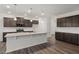 Bright kitchen featuring a granite island and dark cabinets with a white backsplash at 413 Providence Springs Ln, Fuquay Varina, NC 27526