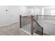Staircase with carpeted steps and decorative metal and wood railing at 413 Providence Springs Ln, Fuquay Varina, NC 27526