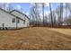 View of the expansive newly seeded backyard and home exterior at 42 Turkey Ct, Timberlake, NC 27583