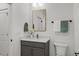 Bathroom with a gray vanity, modern faucet, and decorative mirror at 42 Turkey Ct, Timberlake, NC 27583