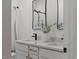 Bright bathroom featuring double sinks, quartz counters, and modern black fixtures at 42 Turkey Ct, Timberlake, NC 27583