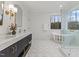 This bathroom boasts a glass enclosed shower, dual sink vanity, and a soaking tub by a window offering abundant natural light at 42 Turkey Ct, Timberlake, NC 27583