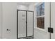 Bathroom featuring a tile shower with black trim and an exterior window at 42 Turkey Ct, Timberlake, NC 27583