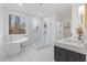 Bright bathroom features a modern tub, glass shower, and marble vanity with sleek fixtures and beautiful tile flooring at 42 Turkey Ct, Timberlake, NC 27583