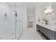 This bathroom offers a glass shower, dual sink vanity with marble countertop, modern fixtures, and access to a walk-in closet at 42 Turkey Ct, Timberlake, NC 27583